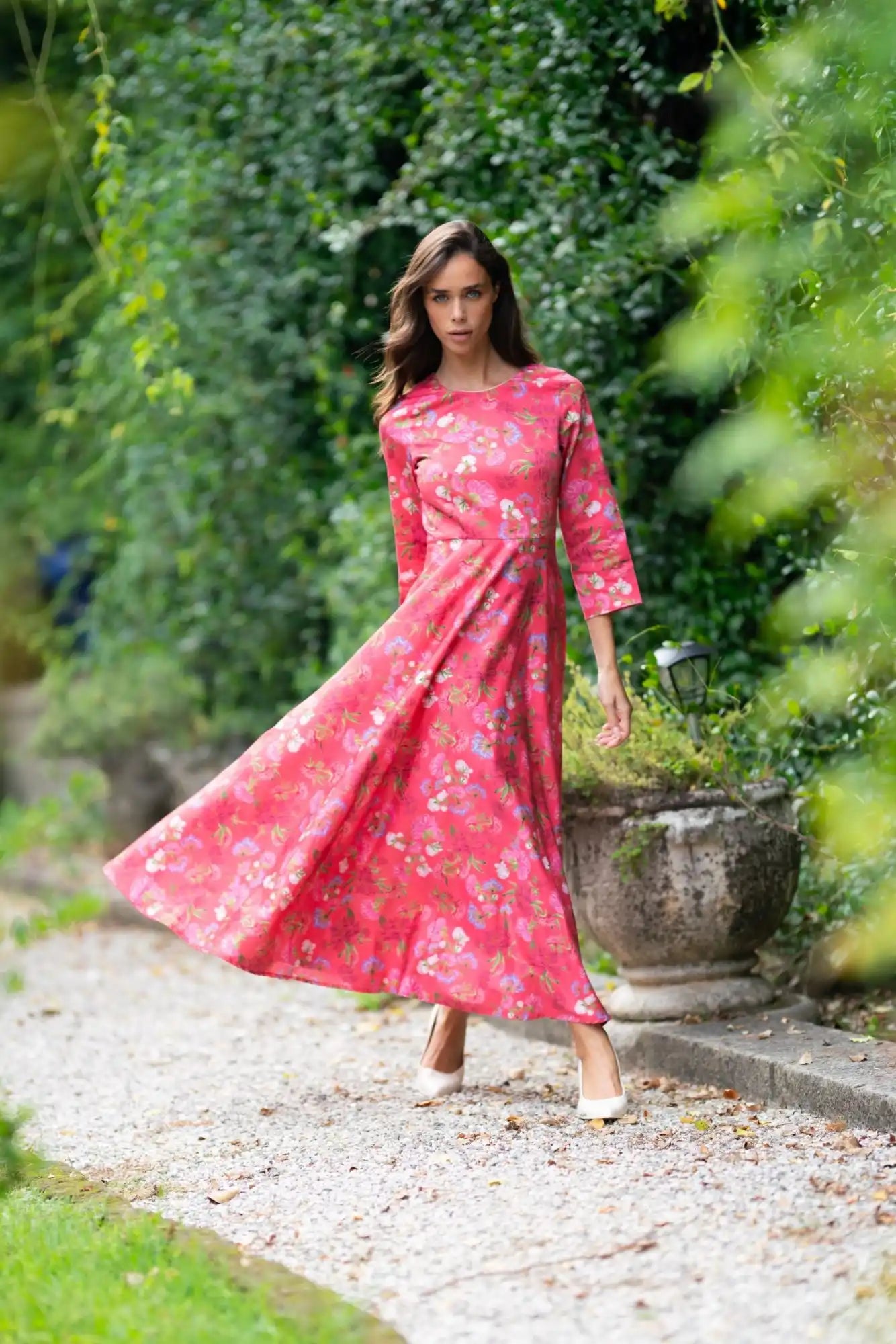 A full-length, floral-patterned, dark pink dress with three-quarter sleeves.